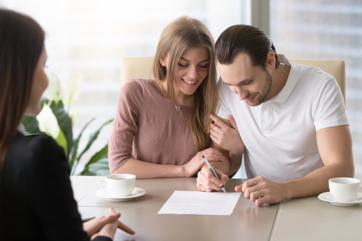 Happy Family Couple Signing Document